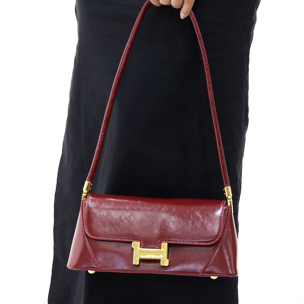 Sarcolite glossy red shoulder bag with gold buckle