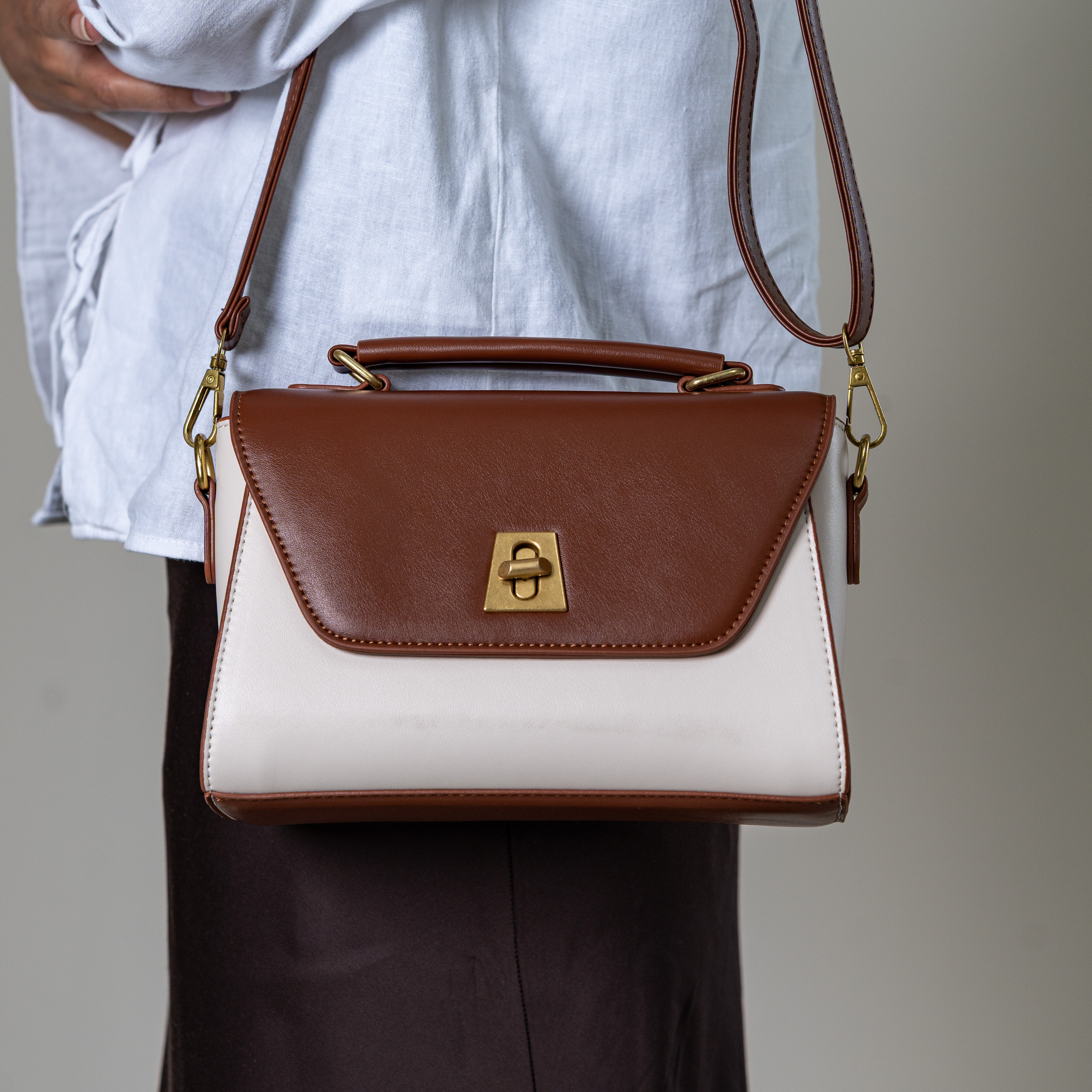 Nicco two-tone structured handbag with gold lock detail