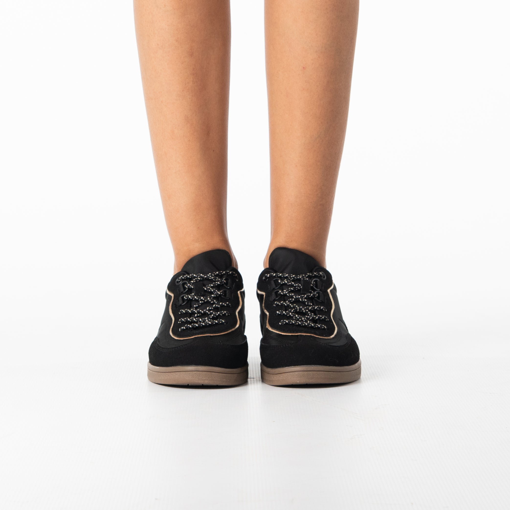 Uma women's sleek black sneaker with gold zip detail