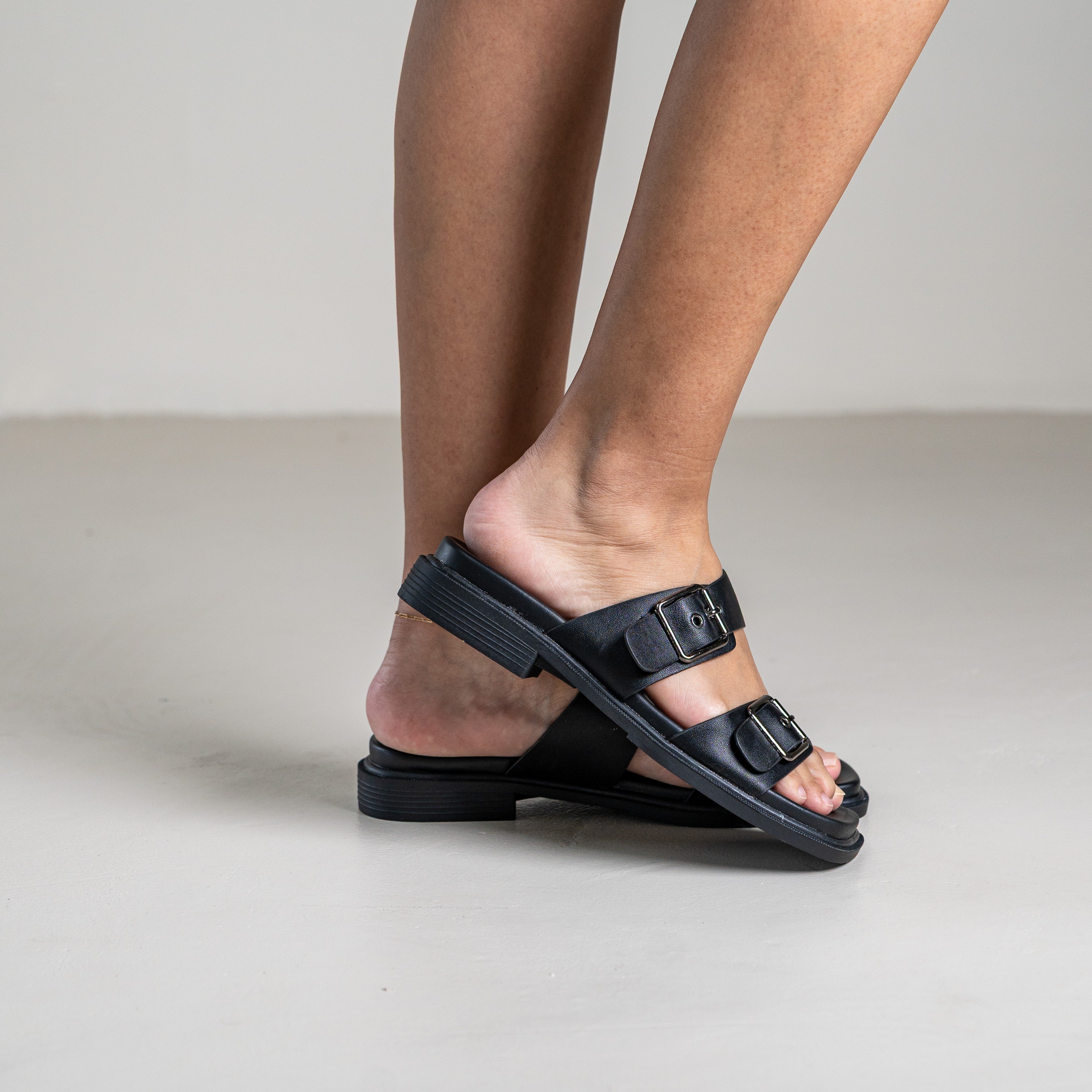 Brevyn slide sandal with wide strap and metal stud