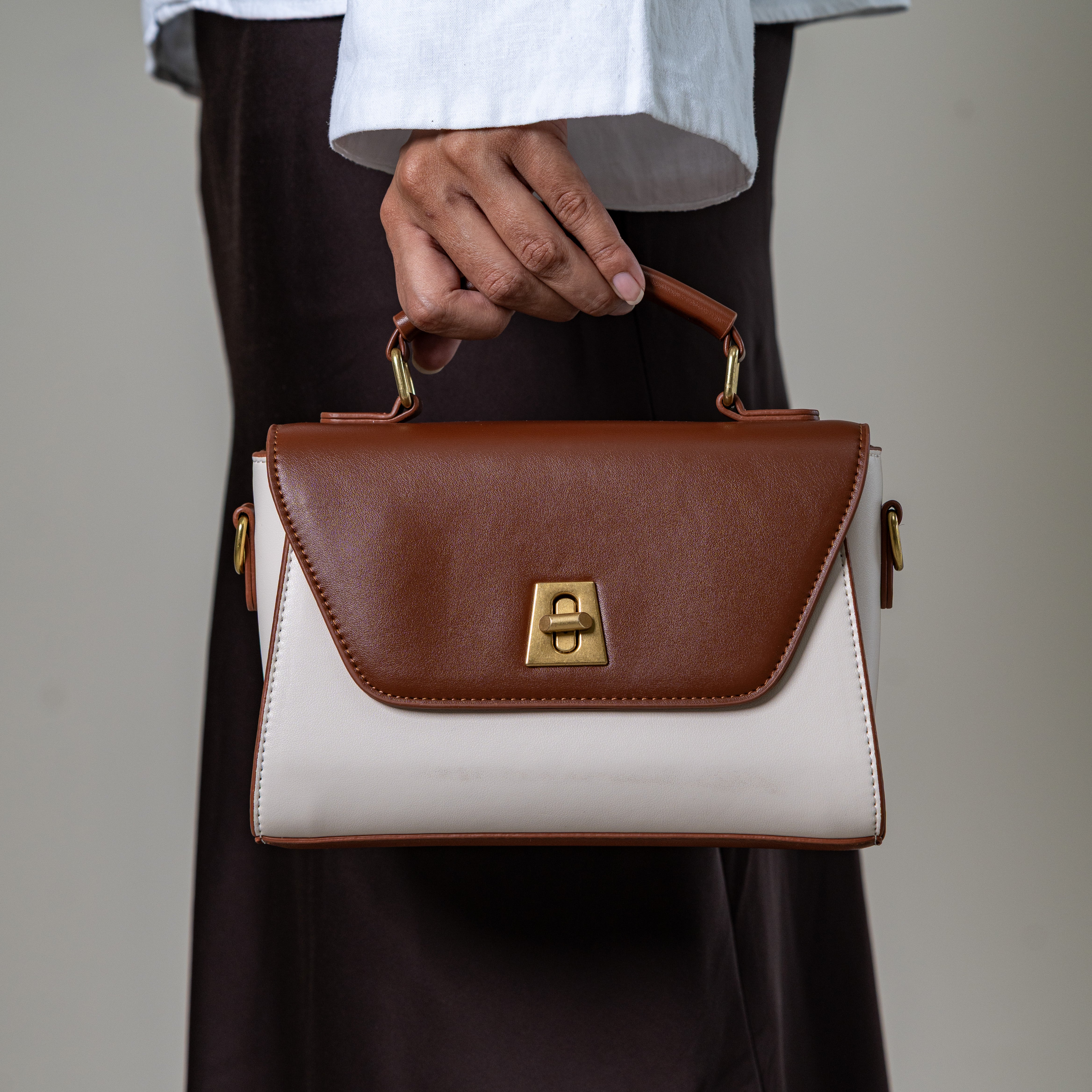 Nicco two-tone structured handbag with gold lock detail