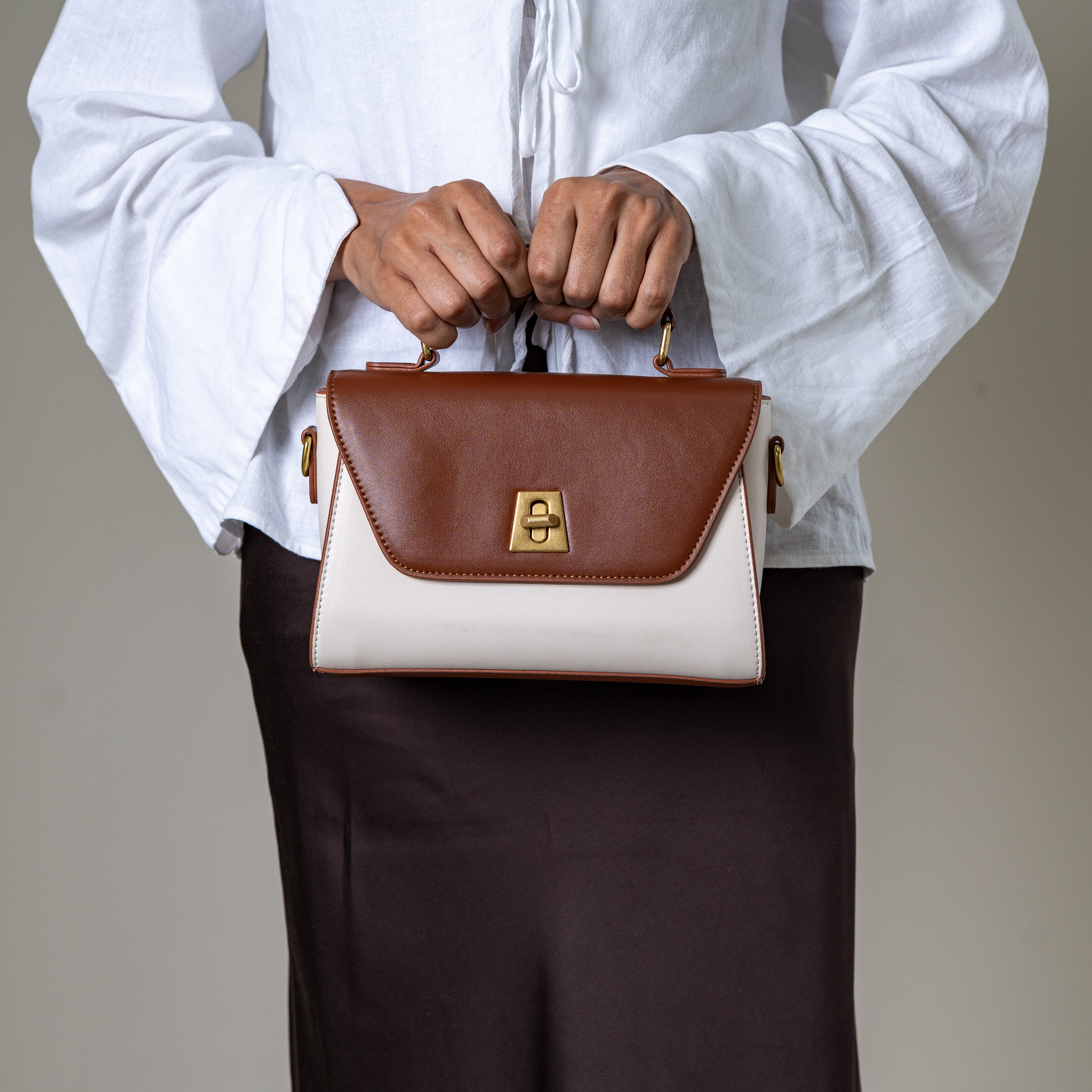 Nicco two-tone structured handbag with gold lock detail