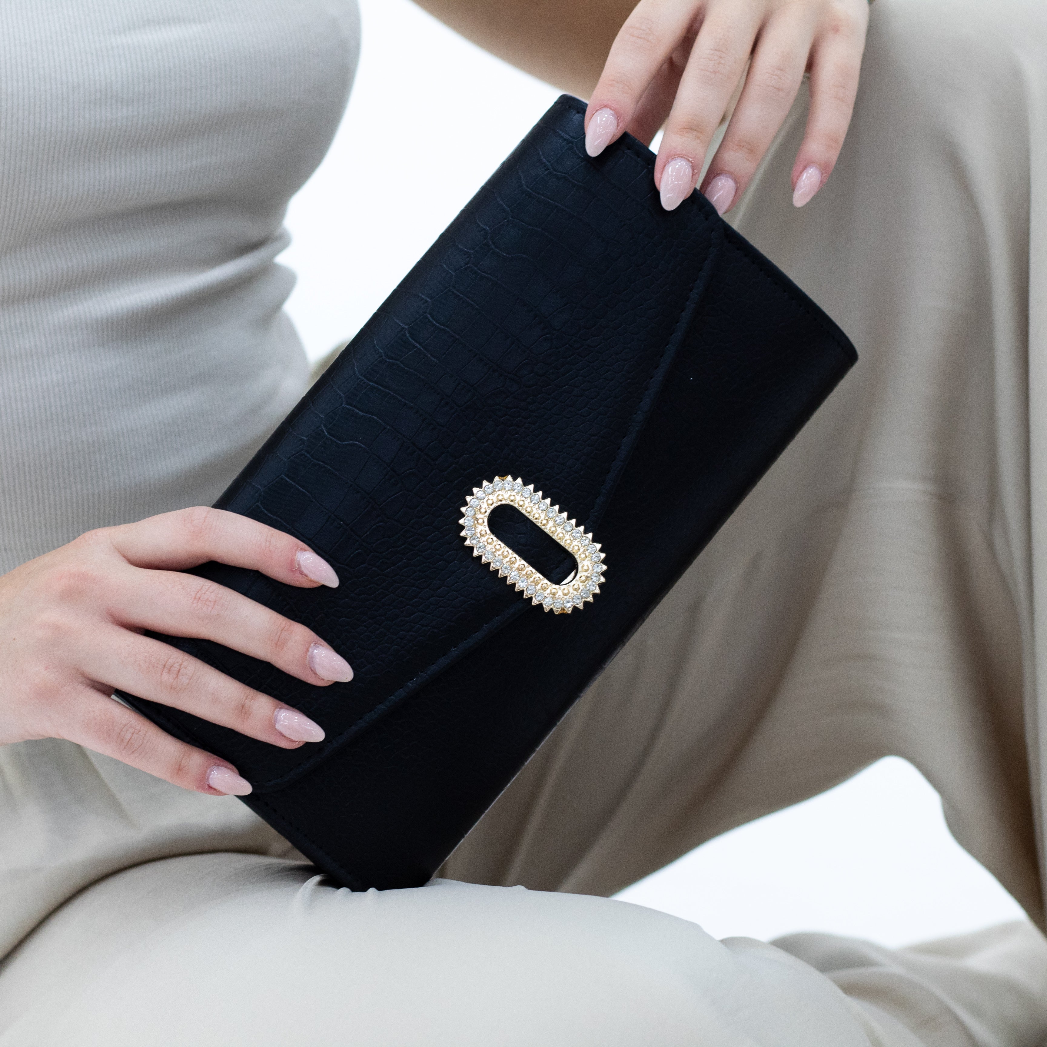 Zina faux leather gold oval trim clutch bag black